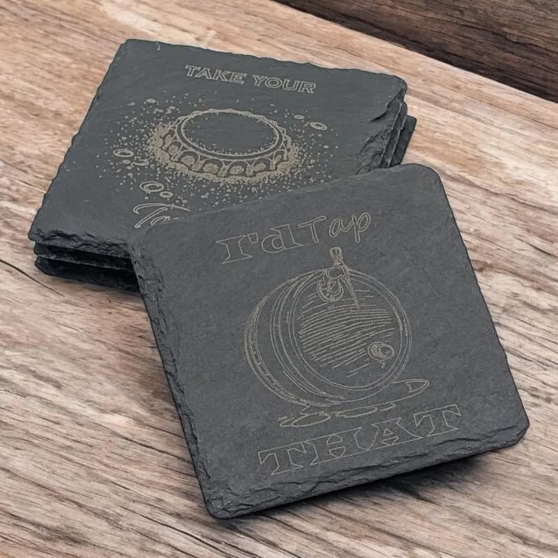 Laser-engraved hexagonal slate coasters with MTG Phyrexian mana symbol